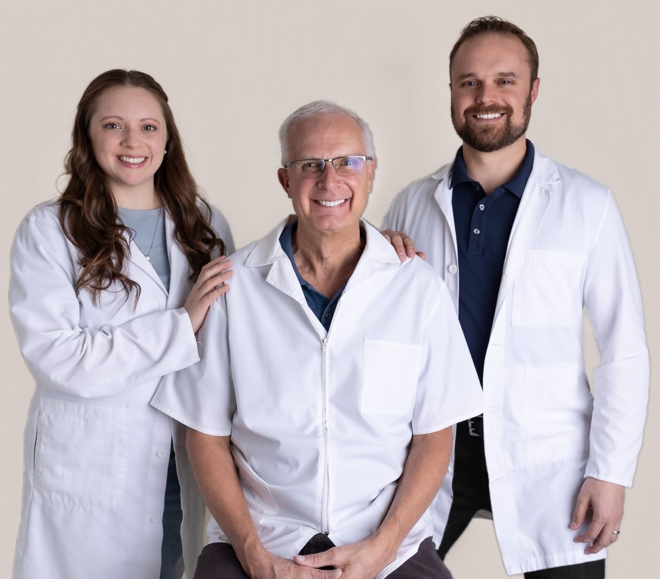 Dr. Sandra Frederick, Dr. Roy Petras and Dr. Dennis Petras in white coats